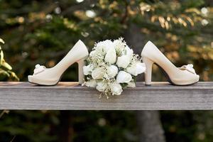 Wedding shoes and bouquet outside photo