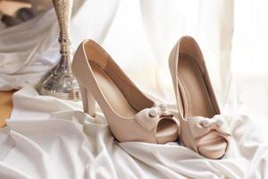 Wedding shoes on white cloth photo