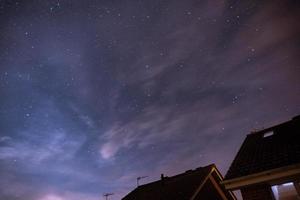 Roofs under a starry sky photo