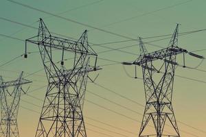 Black transmission towers under green sky photo