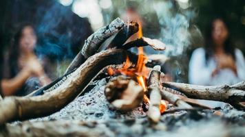 Two people sitting at campfire photo