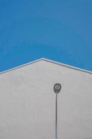 Lamp post near white concrete building  photo