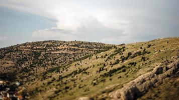 Tilt shift of a green mountain range photo