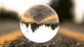 Glass ball on road during daytime photo