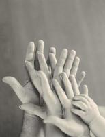 Grayscale of family's hands photo