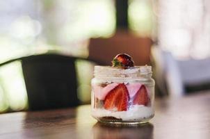 Strawberries and creme in glass jar photo