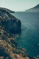 Cliff near body of water photo