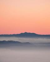 Gray mountain under sunset sky photo