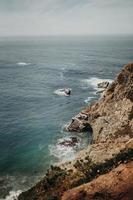 Brown cliff near ocean photo