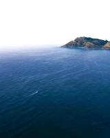 Sea near the mountain during daytime photo