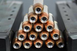 Hollow point, copper jacketed bullets stacked in a pyramid photo