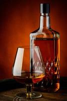 glass and bottle of cognac