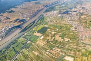 aerial of small village with fields at river rhine
