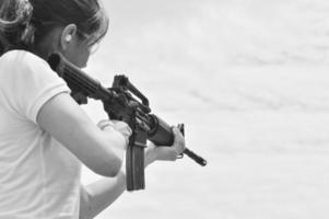 mujer militar apuntando su arma foto