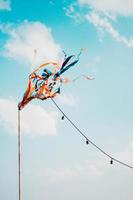 String lights and streamers under clear blue sky photo