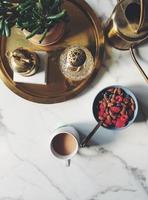 Bowl of cereal beside coffee photo