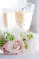 elegant bouquet of flowers and two glasses with wine