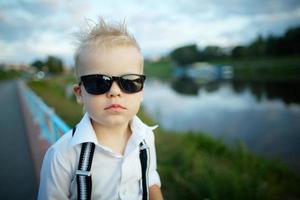 little gentleman with sunglasses outdoors