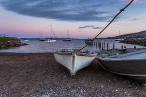 Boats on sand and in water photo