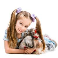 little girl is with her dog Yorkshire Terrier