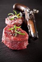 Fresh raw beef steak on black stone photo