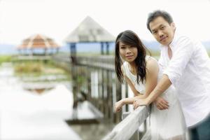 Beautiful married couple on the wooden bridge. photo