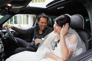 gorgeous wedding couple in car