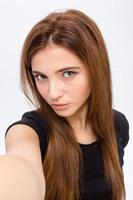 Attractive natural young female making selfie photo