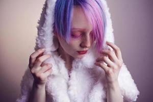 unusual girl with pink hair, feel cold  in fur coat photo