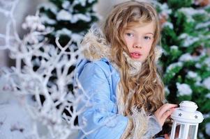 Girl in Christmas decorations photo