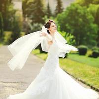 happy brunette bride spinning around with veil