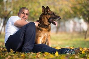 Man Holding Dog German Shepherd photo