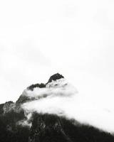 Black and white photo of foggy mountain