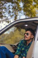 Young man sitting in car photo