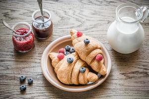 Croissants with fresh berries and jam photo