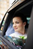 Happy bride in a wedding car