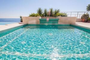 Luxury swimming pool and blue water photo