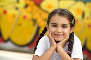 Smiling Cute Little Girl with Hands on Face photo
