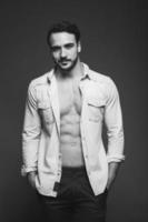 athletic man with unbuttoned shirt, black and white photo