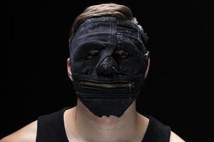 Portrait of the young man in handmade mask