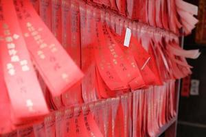 Red paper strips hanging on wall photo