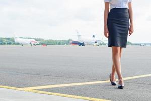 Stewardess on the airfield. Place for your text. photo