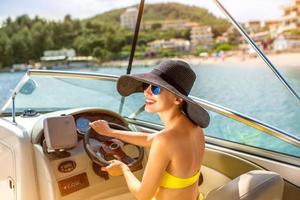 Woman driving yacht photo