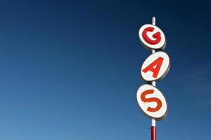 White and red retro gas sign against a blue sky background photo