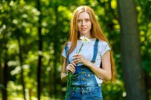 Beautiful smiling red-haired young woman photo