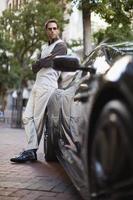 Man leaning on sports car