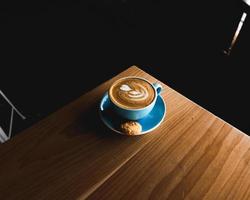 Blue ceramic teacup of latte photo