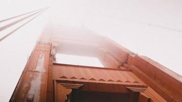 Looking up at fog and the golden gate bridge photo