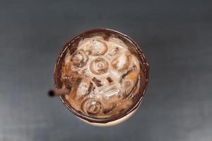 Iced coffee on wooden table photo