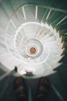 Person standing on spiral staircase photo
